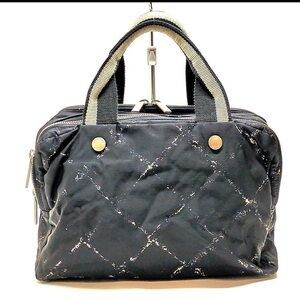 CHANEL Cream and Black Travel Bag with Elegant Design